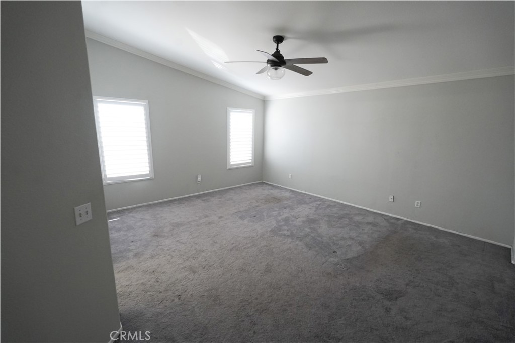 1464 Augusta Street Beaumont, CA 92223 - Photo 11 of 32 an empty room with windows and fan