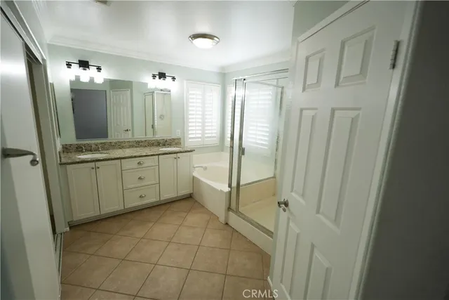 a bathroom with a mirror a sink and glass door