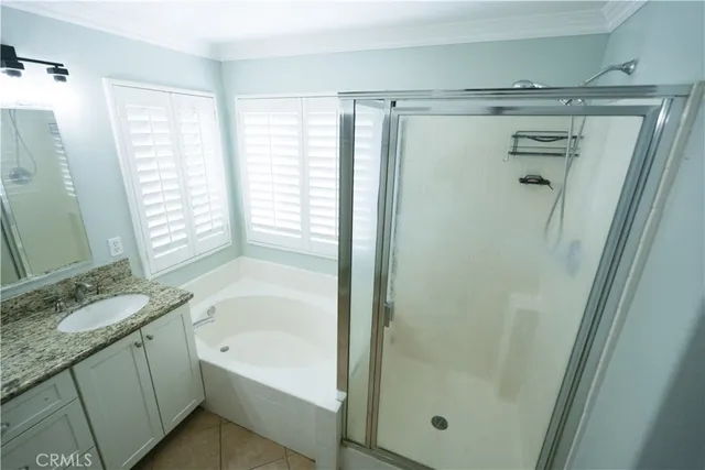 a bathroom with a granite countertop sink a mirror toilet and bathtub