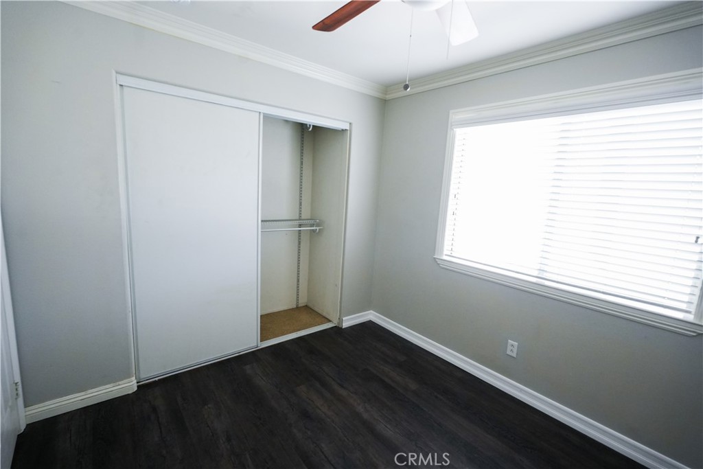 1464 Augusta Street Beaumont, CA 92223 - Photo 17 of 32 a view of an empty room with wooden floor and a window
