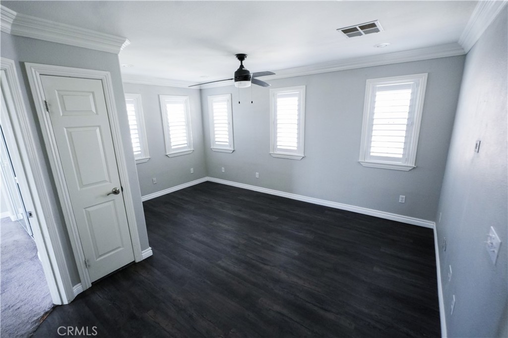 1464 Augusta Street Beaumont, CA 92223 - Photo 24 of 32 an empty room with wooden floor and windows