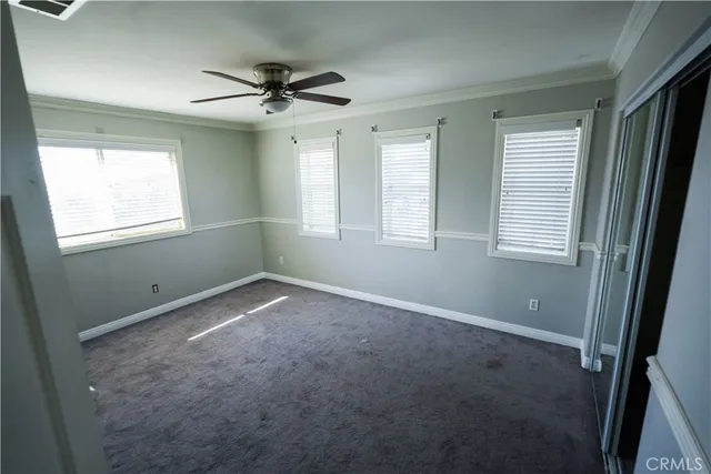 a view of a livingroom with a ceiling fan and window