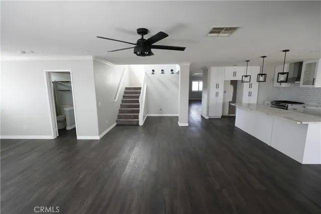 a view of a kitchen with a sink and a refrigerator