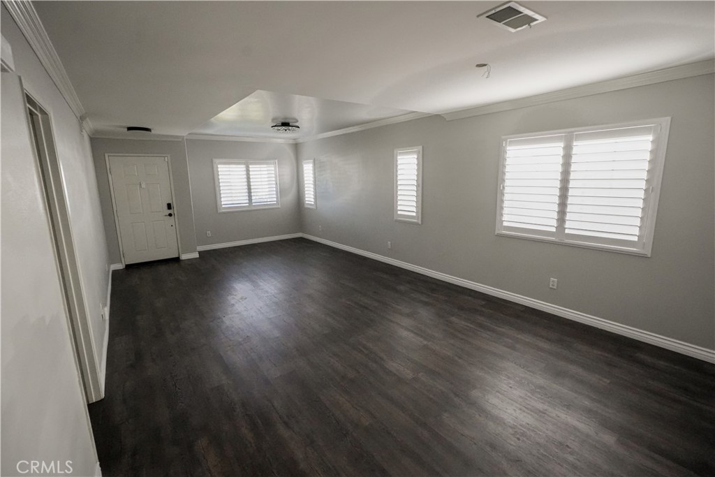 1464 Augusta Street Beaumont, CA 92223 - Photo 9 of 32 a view of an empty room with wooden floor and a window