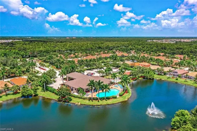 an aerial view of residential houses with outdoor space and lake view