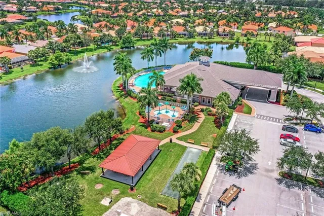 an aerial view of a house with a garden and lake view