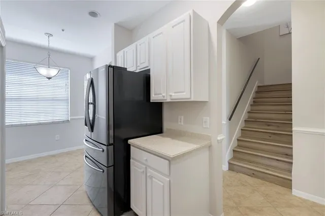 a kitchen with stainless steel appliances a refrigerator and a cabinets