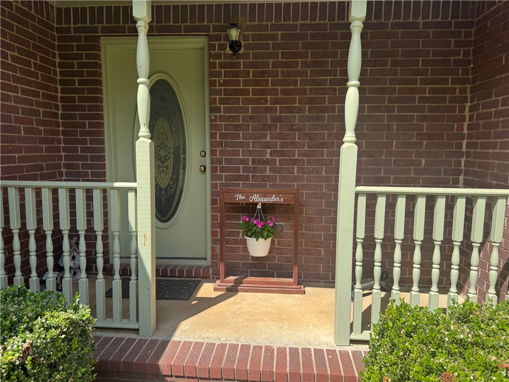 95 Deer Run Road Delaware, AR 72835 - Photo 13 of 40 Brick exterior featuring a covered porch with concrete flooring