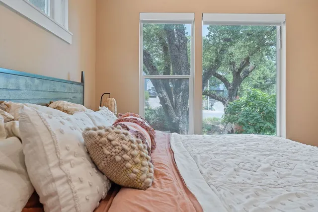 a bedroom with a large bed and a window