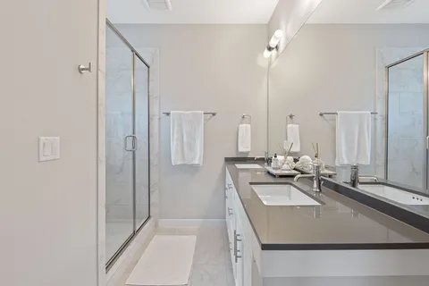 a view of a bathroom with a sink and a mirror