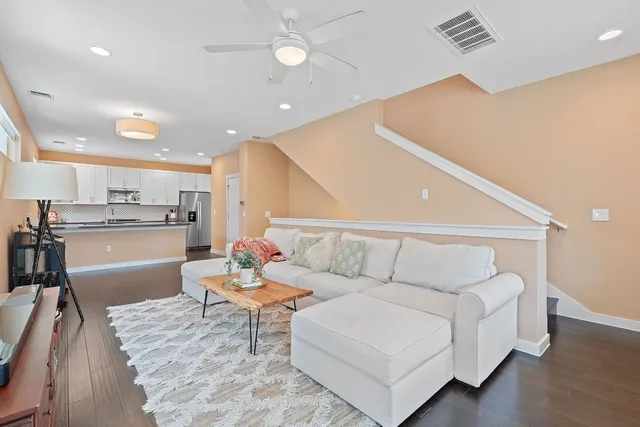 a living room with furniture and kitchen view