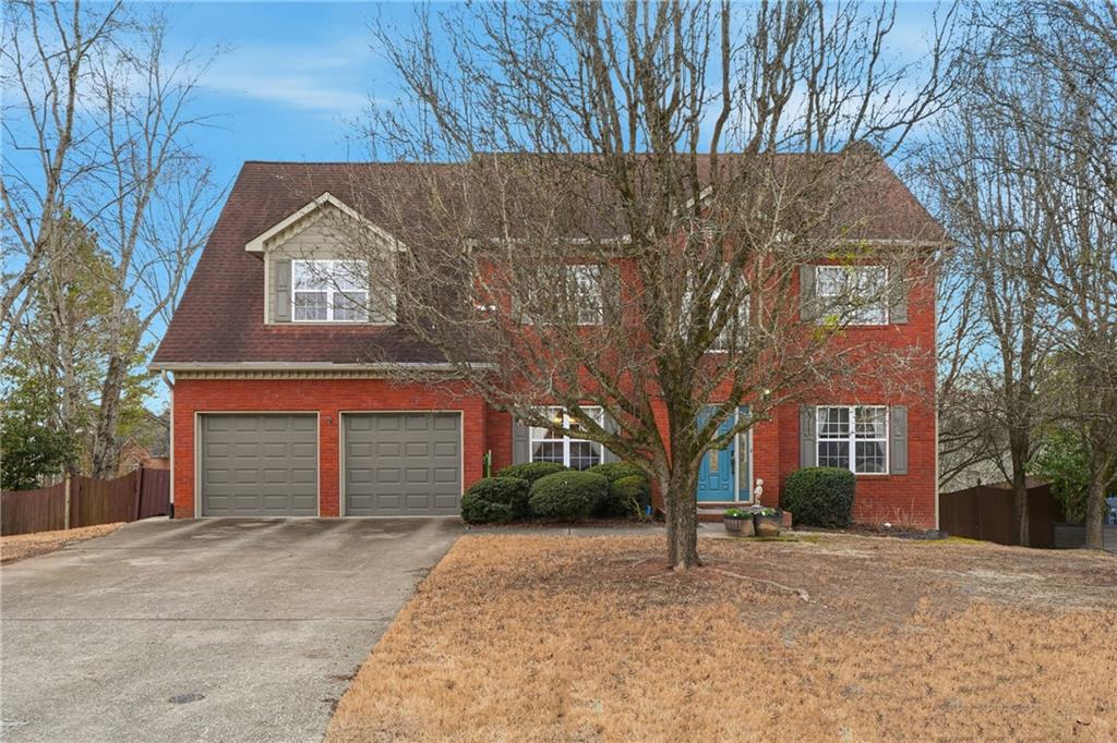 1770 Clayhill Pointe Southwest Marietta, GA 30064 - Photo 1 of 1 a front view of a house with a yard and garage