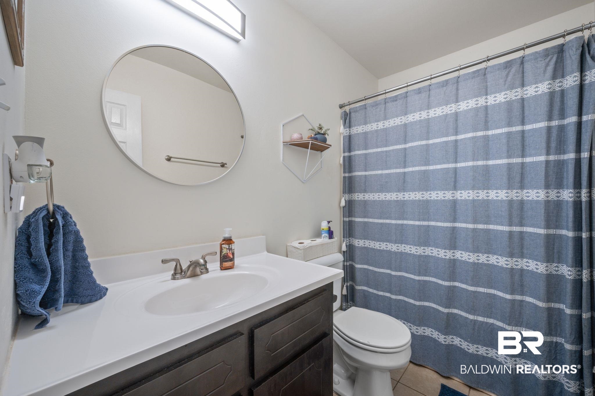 13025 County Road 55 Foley, AL 36535 - Photo 6 of 49 Bathroom with a shower with curtain, vanity, tile patterned flooring, and toilet