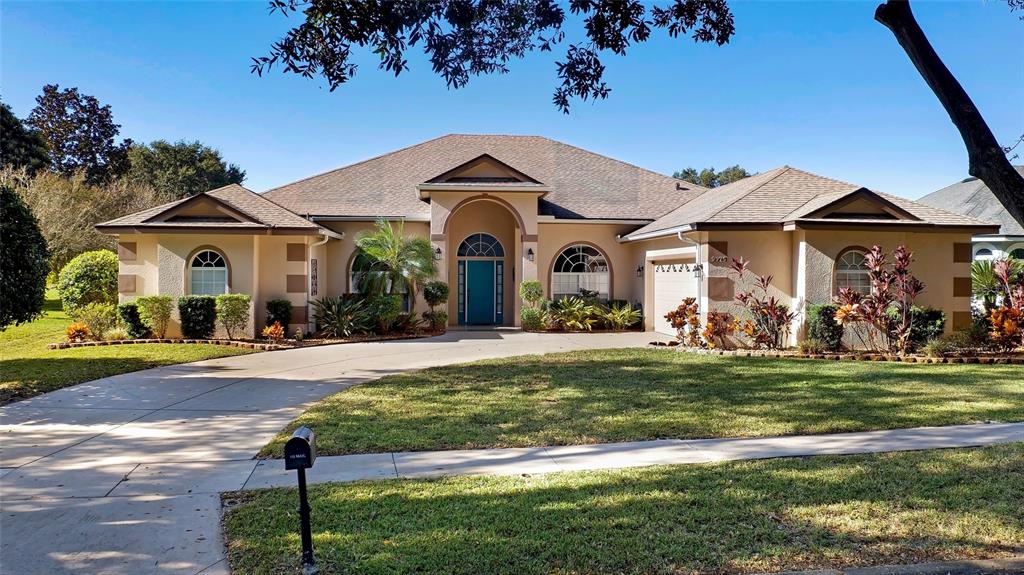 9925 Spring Lake Drive Clermont, FL 34711 - Photo 1 of 1 a front view of a house with a garden