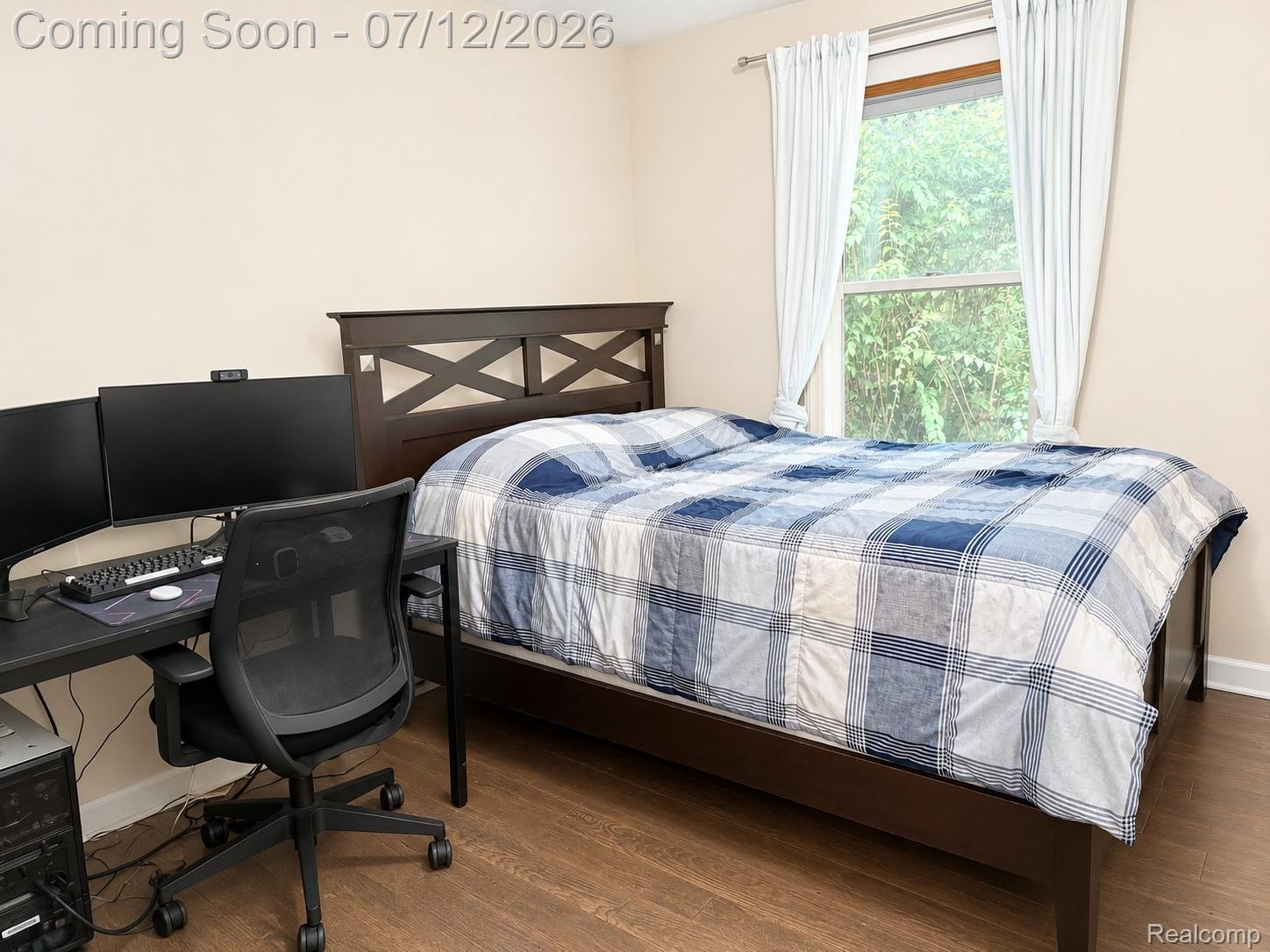 2033 Avonstoke Road Rochester, MI 48307 - Photo 12 of 26 Bedroom featuring wood-finish flooring, a double-hung window with white curtains, and neutral wall tones