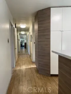 a view of a hallway with wooden shelves