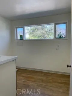 a view of lot of window and wooden floor
