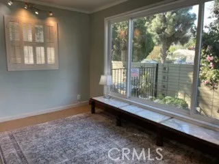 a view of a room that has a bed and windows