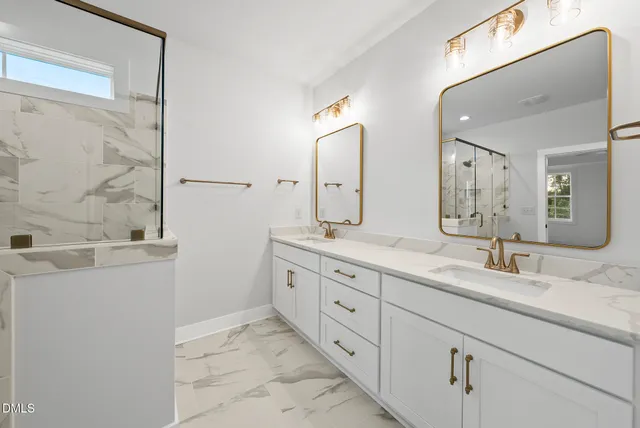a bathroom with double sink and a mirror