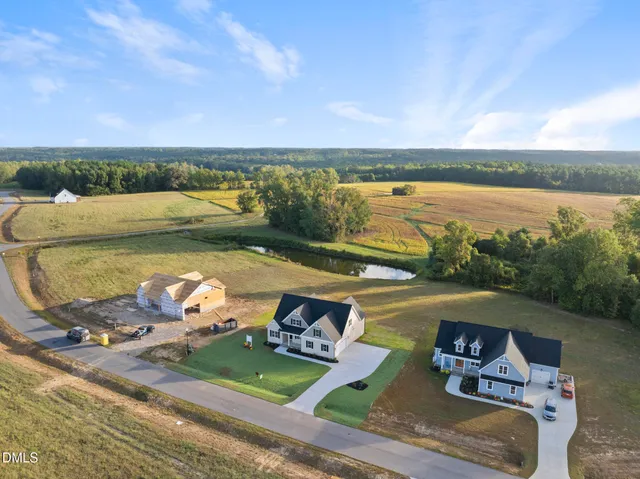 a view of a lake with a table and chairs in the patio
