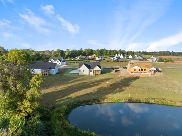 a view of a lake with houses in the back