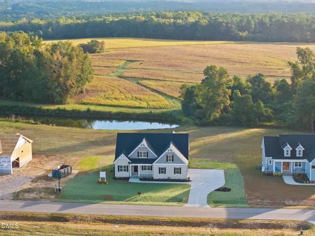 a view of a lake with a house in the background