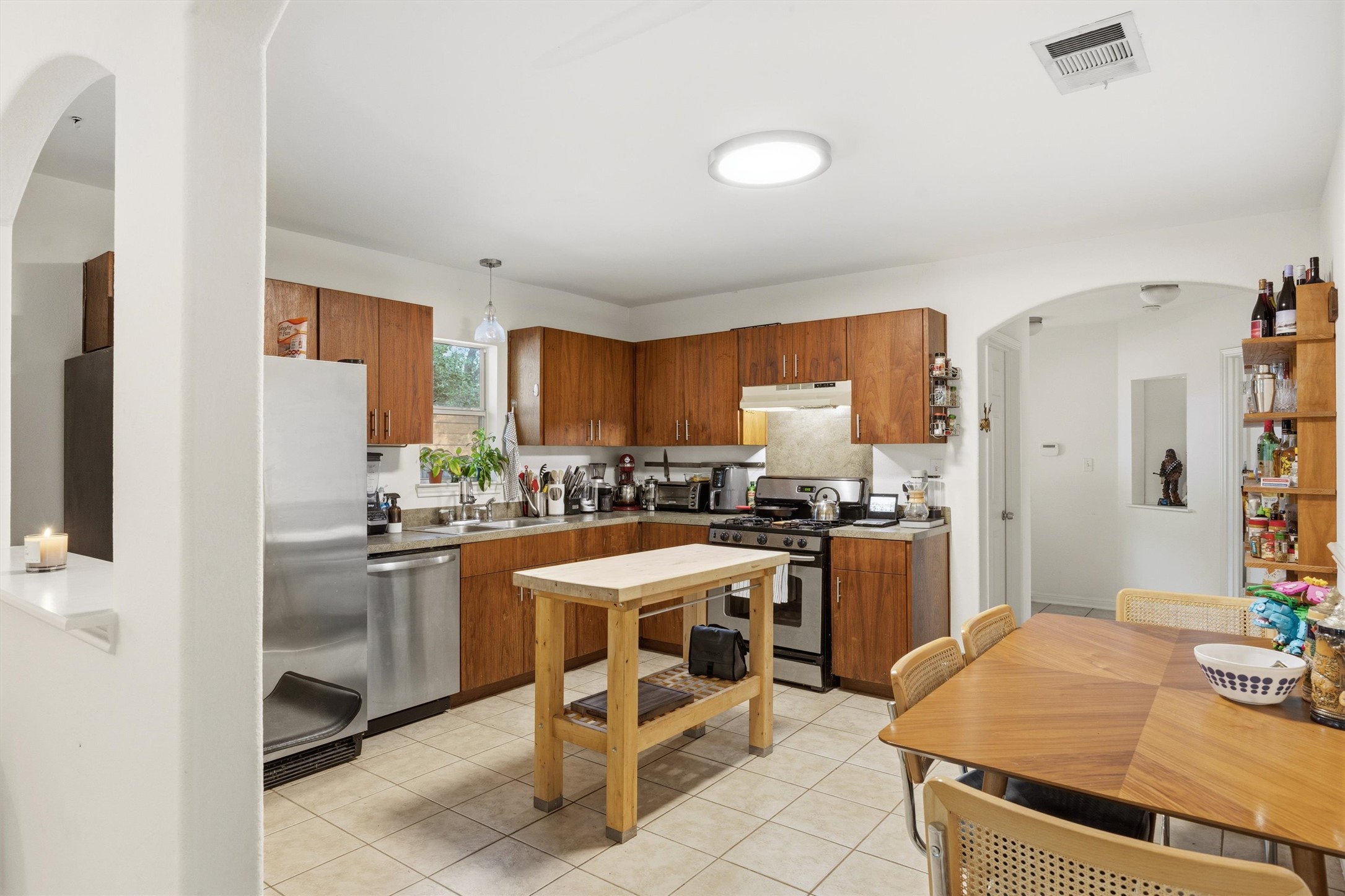 3015 Castro Street Austin, TX 78702 - Photo 11 of 40 A functional kitchen, perfect for casual meals, features wood cabinetry and stainless steel appliances.