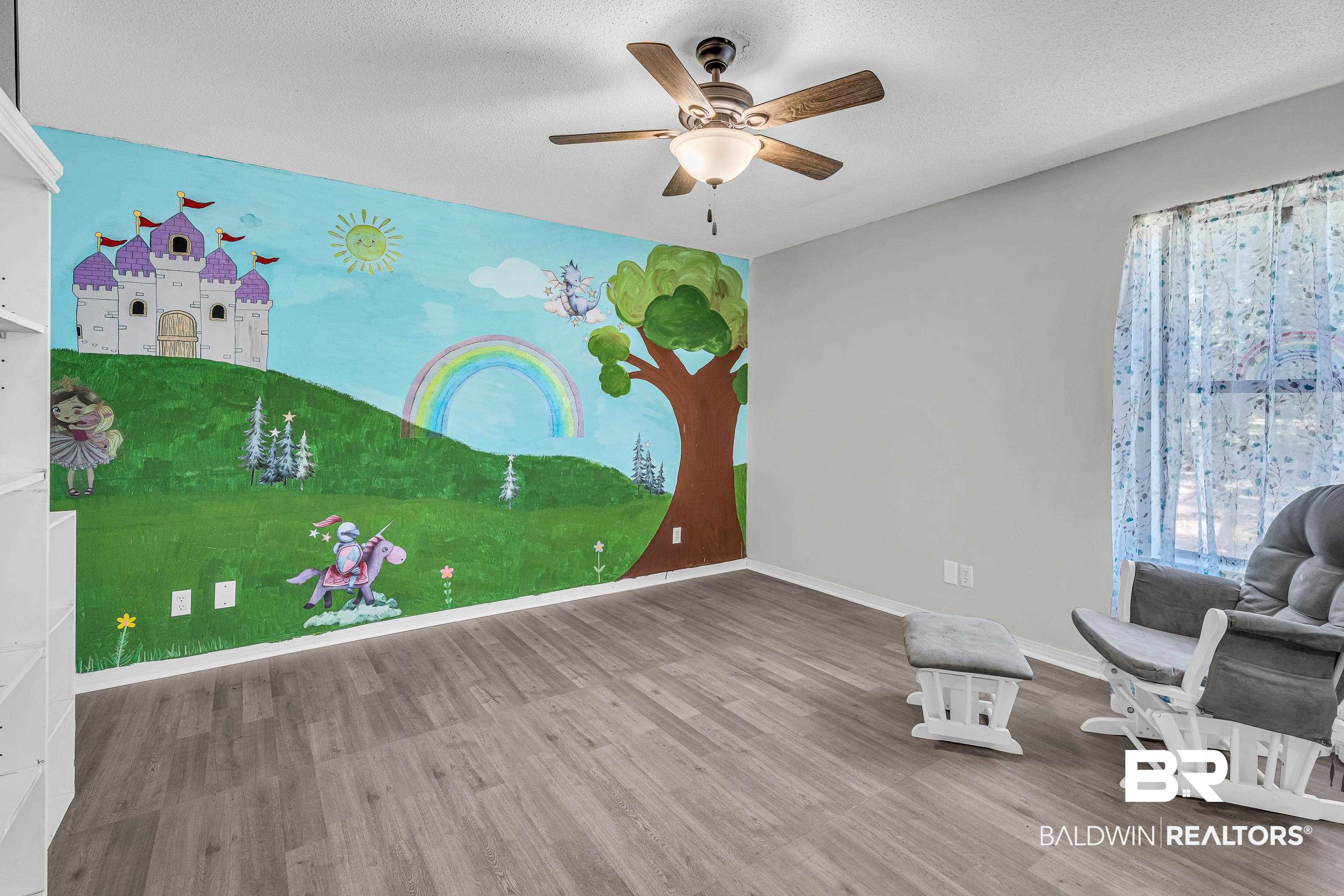 6135 Oak Cliff Drive Eight Mile, AL 36613 - Photo 21 of 30 Unfurnished room with wood finished floors, a textured ceiling, and ceiling fan