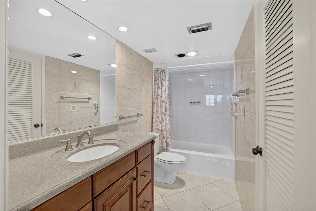 405 North Ocean Boulevard, Unit 1027 Pompano Beach, FL 33062 - Photo 12 of 57 a bathroom with a sink a toilet and shower a mirror