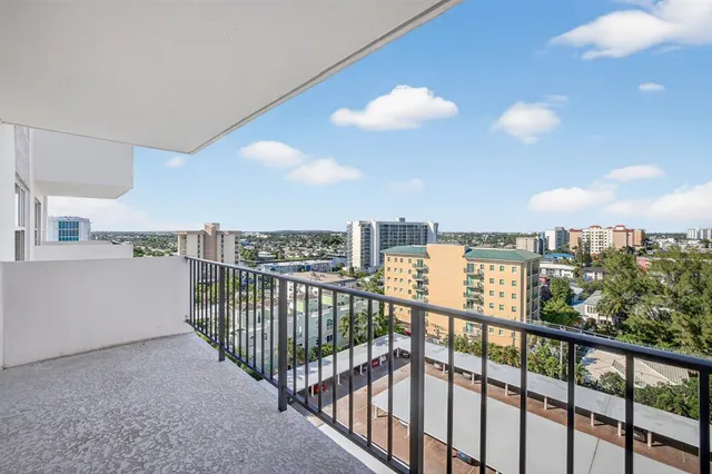 a view of a terrace with lawn chairs