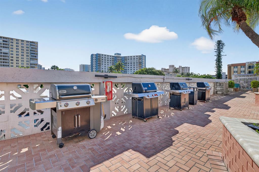 405 North Ocean Boulevard, Unit 1027 Pompano Beach, FL 33062 - Photo 19 of 57 a view of kitchen with stainless steel appliances granite countertop stove top oven and cabinets
