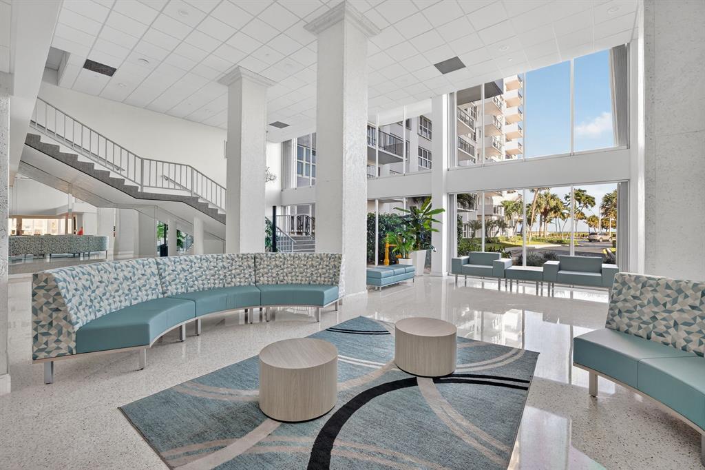 405 North Ocean Boulevard, Unit 1027 Pompano Beach, FL 33062 - Photo 25 of 57 a living room with furniture and a fireplace