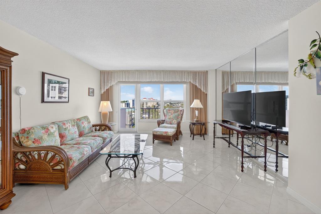 405 North Ocean Boulevard, Unit 1027 Pompano Beach, FL 33062 - Photo 35 of 57 a living room with furniture and a flat screen tv