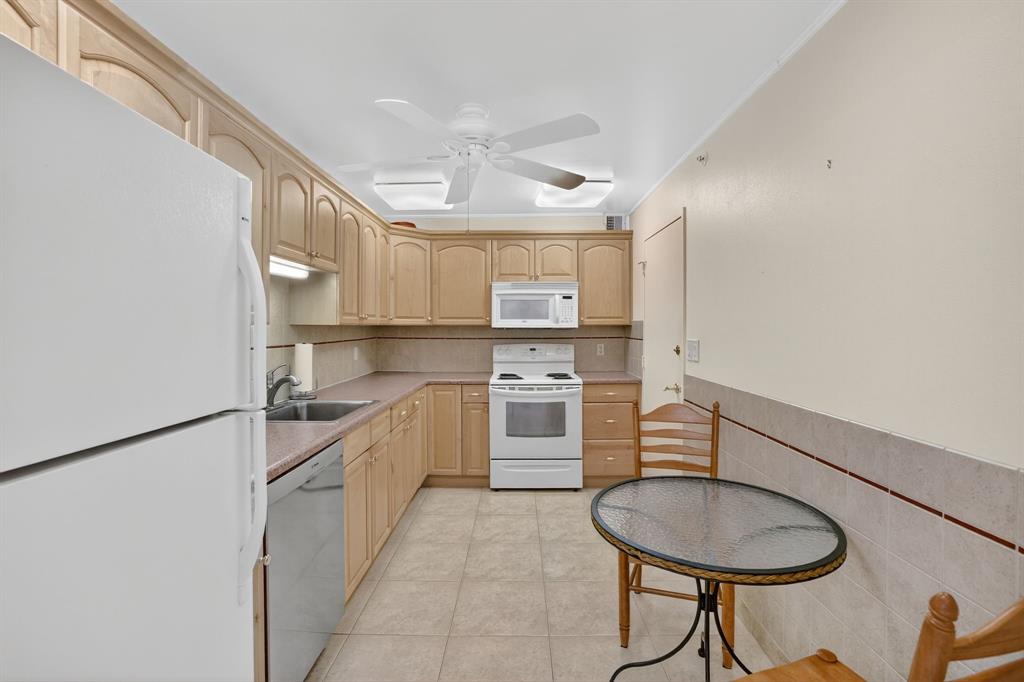 405 North Ocean Boulevard, Unit 1027 Pompano Beach, FL 33062 - Photo 41 of 57 a kitchen with a sink cabinets and window