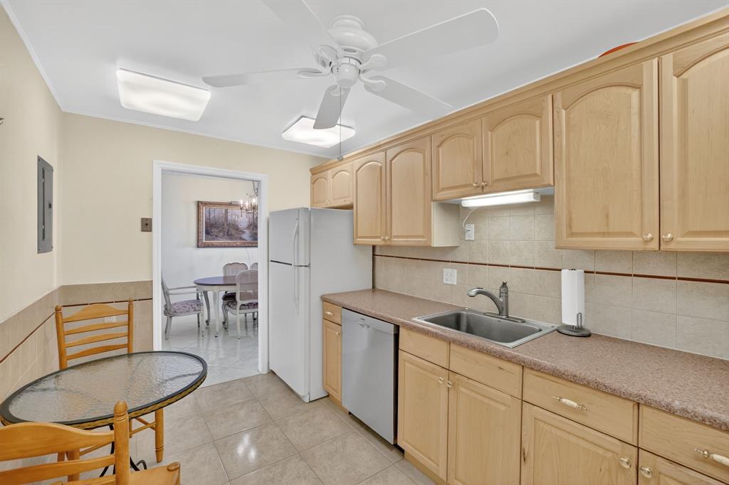 405 North Ocean Boulevard, Unit 1027 Pompano Beach, FL 33062 - Photo 42 of 57 a kitchen with stainless steel appliances granite countertop a sink and a refrigerator