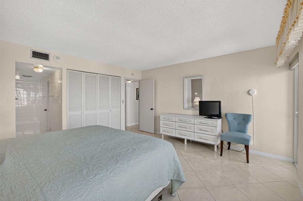 405 North Ocean Boulevard, Unit 1027 Pompano Beach, FL 33062 - Photo 45 of 57 a bedroom with furniture and a window