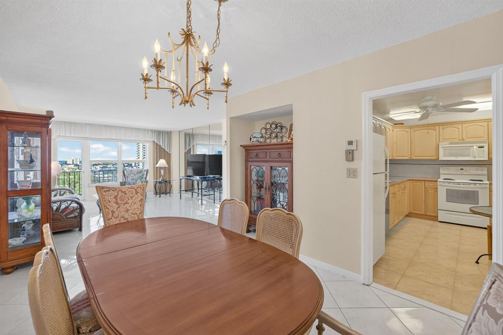 405 North Ocean Boulevard, Unit 1027 Pompano Beach, FL 33062 - Photo 5 of 57 a view of a dining room with furniture and wooden floor