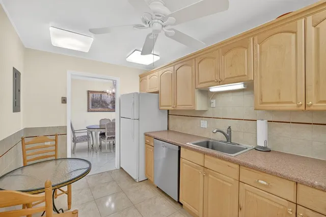 a kitchen with white cabinets stainless steel appliances and sink