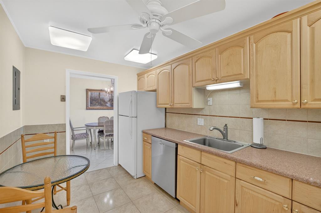 405 North Ocean Boulevard, Unit 1027 Pompano Beach, FL 33062 - Photo 6 of 57 a kitchen with cabinets a sink and appliances