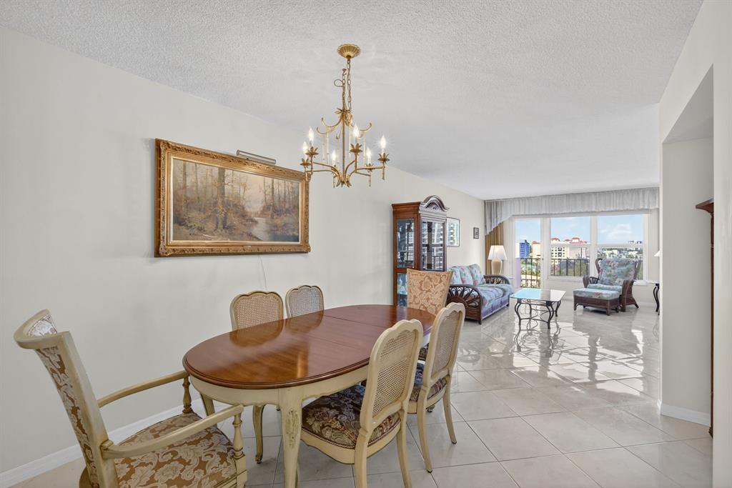 405 North Ocean Boulevard, Unit 1027 Pompano Beach, FL 33062 - Photo 8 of 57 a view of a dining room with furniture and chandelier