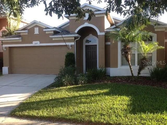 1237 Portmoor Way Winter Garden, FL 34787 - Photo 1 of 9 a front view of a house with a yard