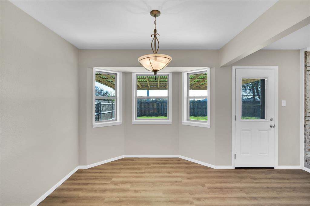 221 North Edgefield Road Waxahachie, TX 75165 - Photo 9 of 27 a view of empty room with wooden floor and fan