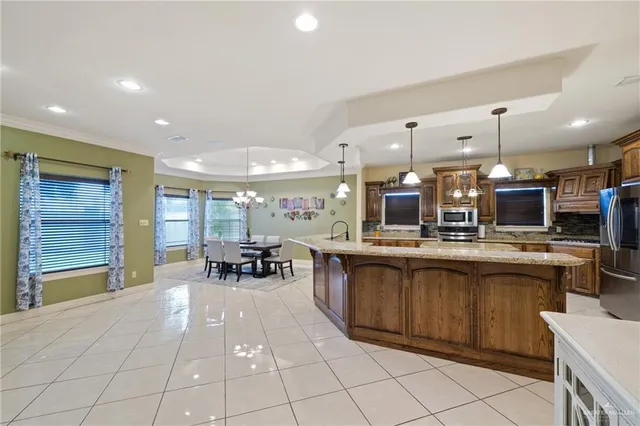 a kitchen with a sink and chairs