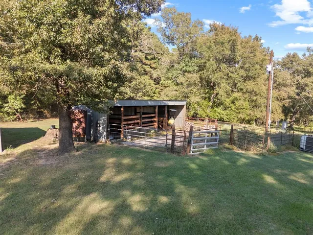 a living room with stainless steel appliances kitchen island furniture and a fireplace