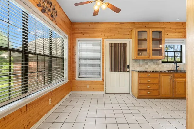 a kitchen with stainless steel appliances granite countertop a sink and a refrigerator