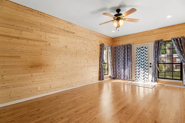 wooden floor in an empty room with a window