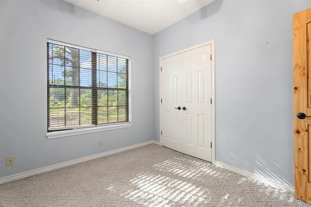 a bathroom with a granite countertop toilet sink and mirror