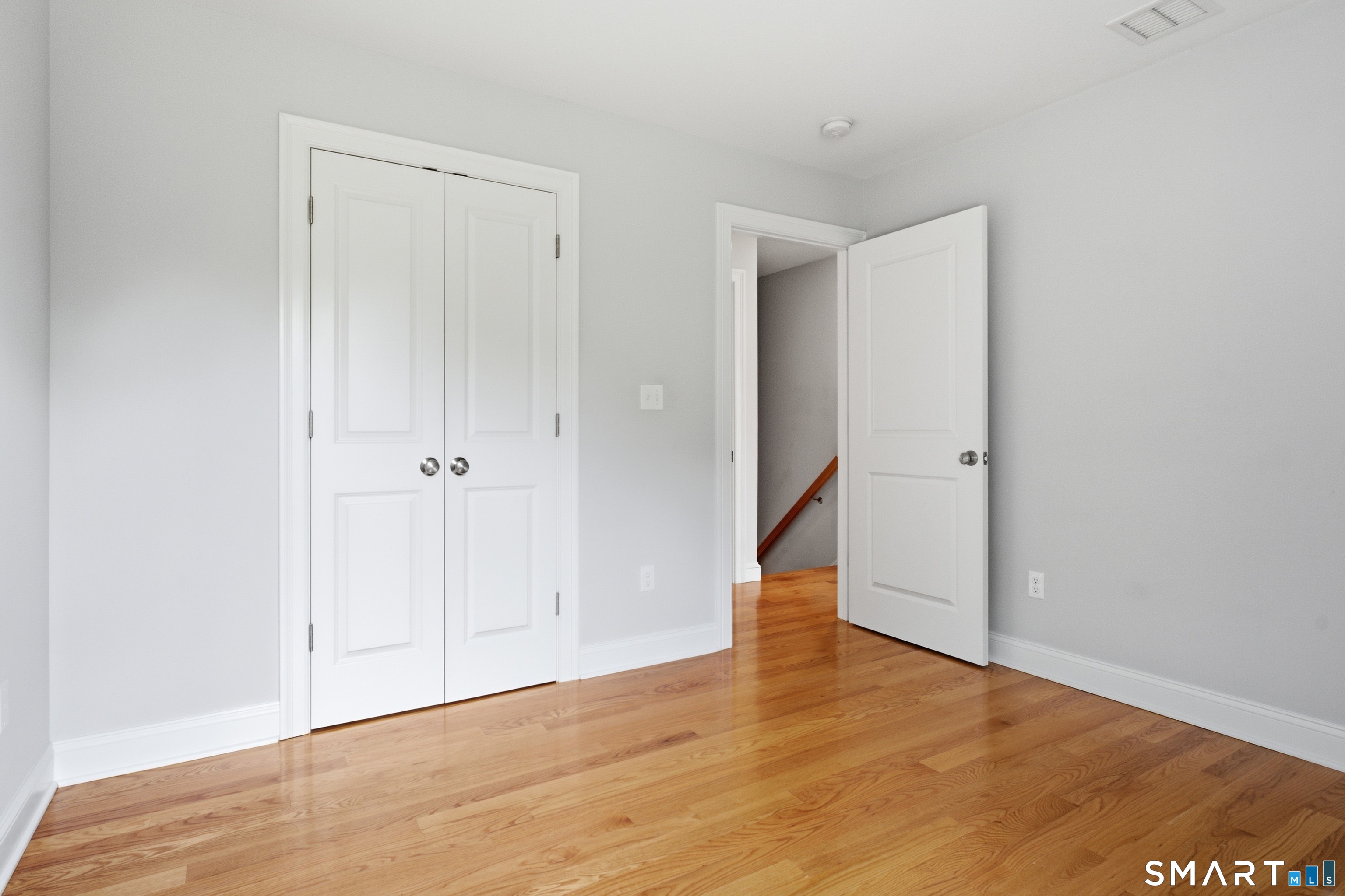 838 Little Meadow Road Guilford, CT 06437 - Photo 22 of 40 Bedroom 3 has hardwood floors and shows the modern 2 panel doors that run throughout the home