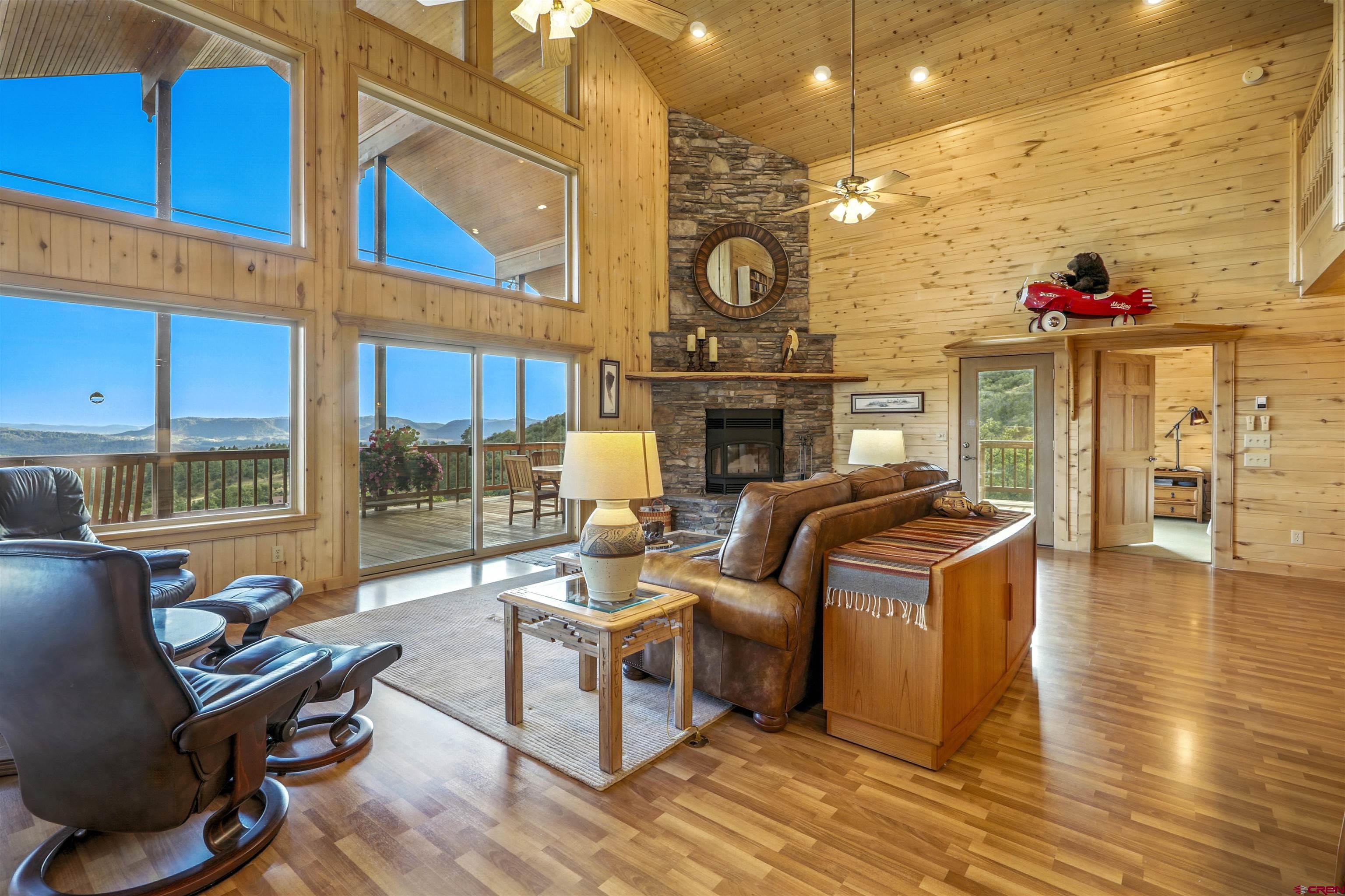 1100 Soaring Eagle Court Chromo, CO 81128 - Photo 12 of 44 a living room with fireplace furniture and a large window