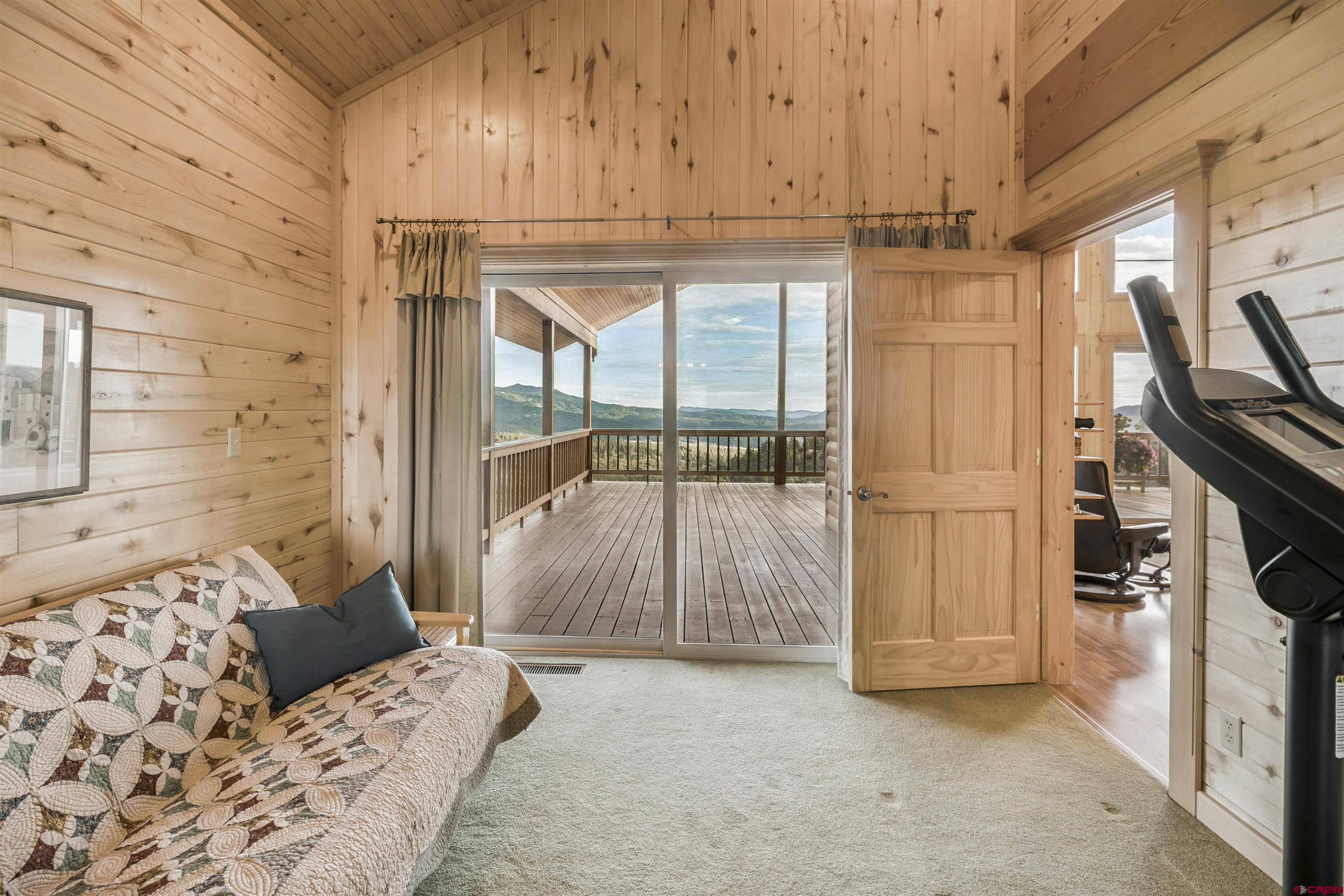 1100 Soaring Eagle Court Chromo, CO 81128 - Photo 18 of 44 a bedroom with a bed and a chandelier